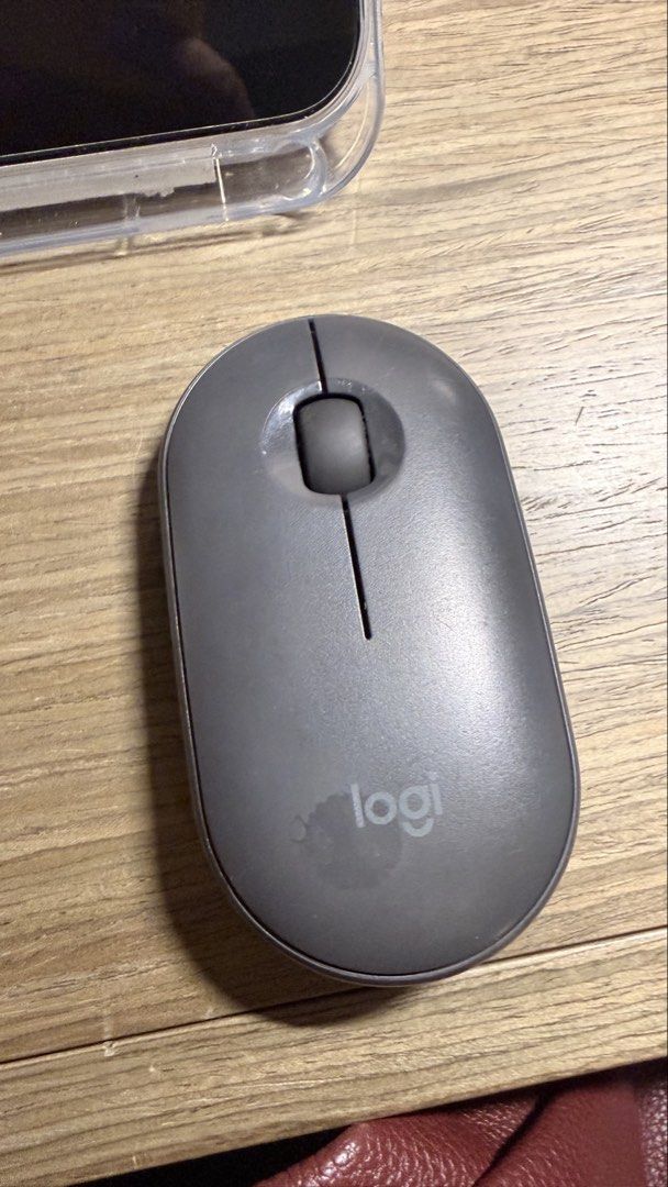 Logitech Pebble M350 Wireless Mouse (Category: Mouse & Mousepads) located in Manila. Submitted by eyaaa (Listing ID 1439027553, Image 1). Description: - Logitech Pebble M350 wireless mouse - Gray color - Sleek, oval design - Features a central scroll wheel and two buttons - On/off switch and button on the bottom - Model number: M350.