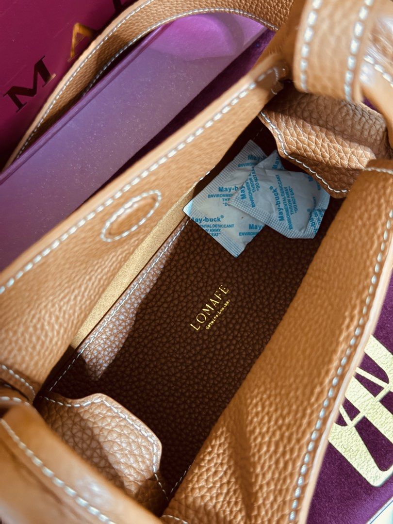 RUSH! Lomafe Mini Fien in Pecan (Category: Cross-body Bags) located in Quezon City. Submitted by finderskeepersbya_ (Listing ID 1438955915, Image 3). Description: Used once Bought last April 11, 2026 in their physical store in QC Inclusions: Dust bag, box, paper bag, receipt Bottom studs still has its covers RFS: Too small for me Note: Willing to trade and add for Lomafe Velisse in Cabernet color. Price is slightly negotiable :).