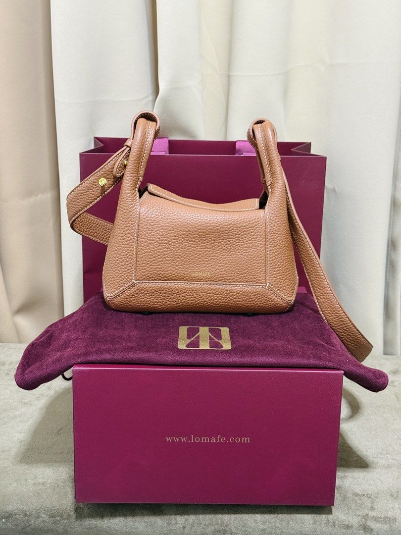 RUSH! Lomafe Mini Fien in Pecan (Category: Cross-body Bags) located in Quezon City. Submitted by finderskeepersbya_ (Listing ID 1438955915, Image 1). Description: Used once Bought last April 11, 2026 in their physical store in QC Inclusions: Dust bag, box, paper bag, receipt Bottom studs still has its covers RFS: Too small for me Note: Willing to trade and add for Lomafe Velisse in Cabernet color. Price is slightly negotiable :).