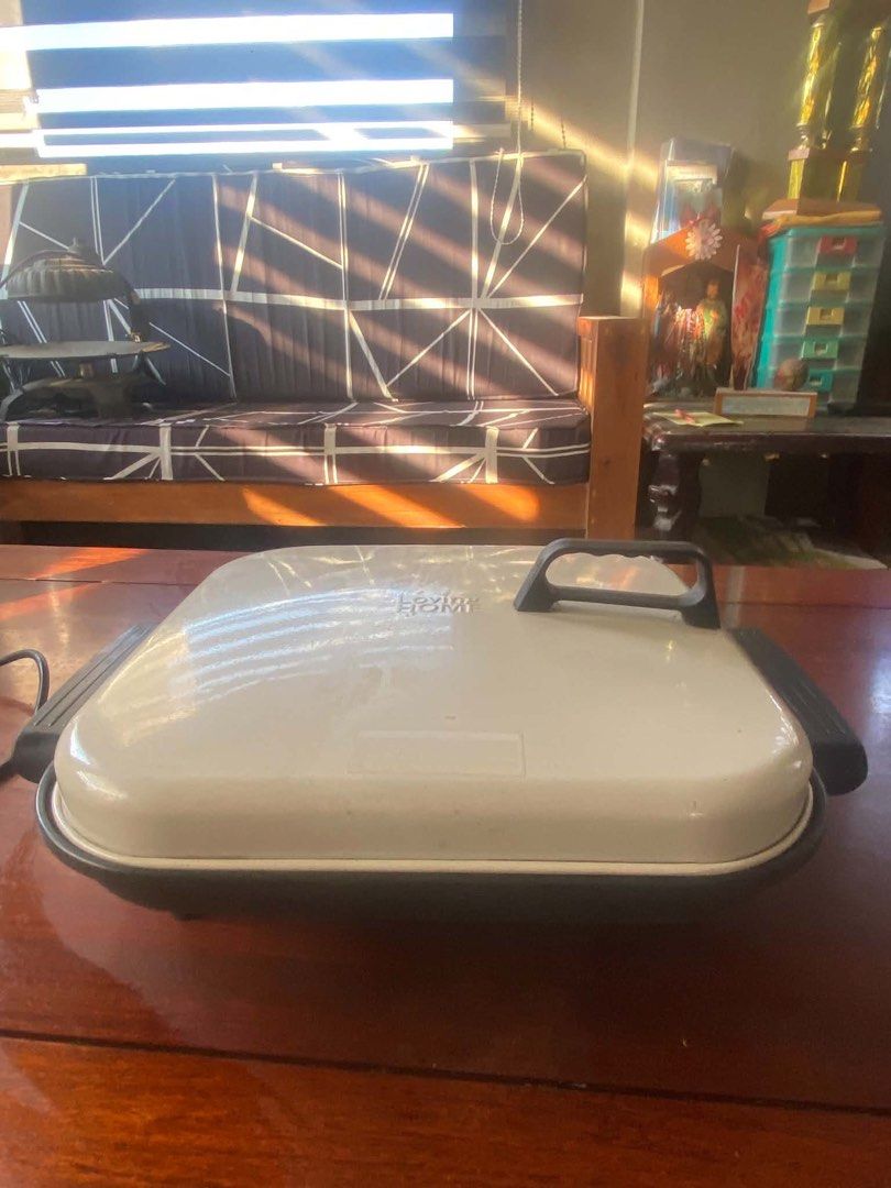 Loving Home Electric Griddle (Category: Cookware & Accessories) located in Apalit. Submitted by aclyd (Listing ID 1438995190, Image 2). Description: - Loving Home electric griddle - Square shape - Includes lid and handles - Features a black base and cream-colored top - In good working condition - Ready for your kitchen!.