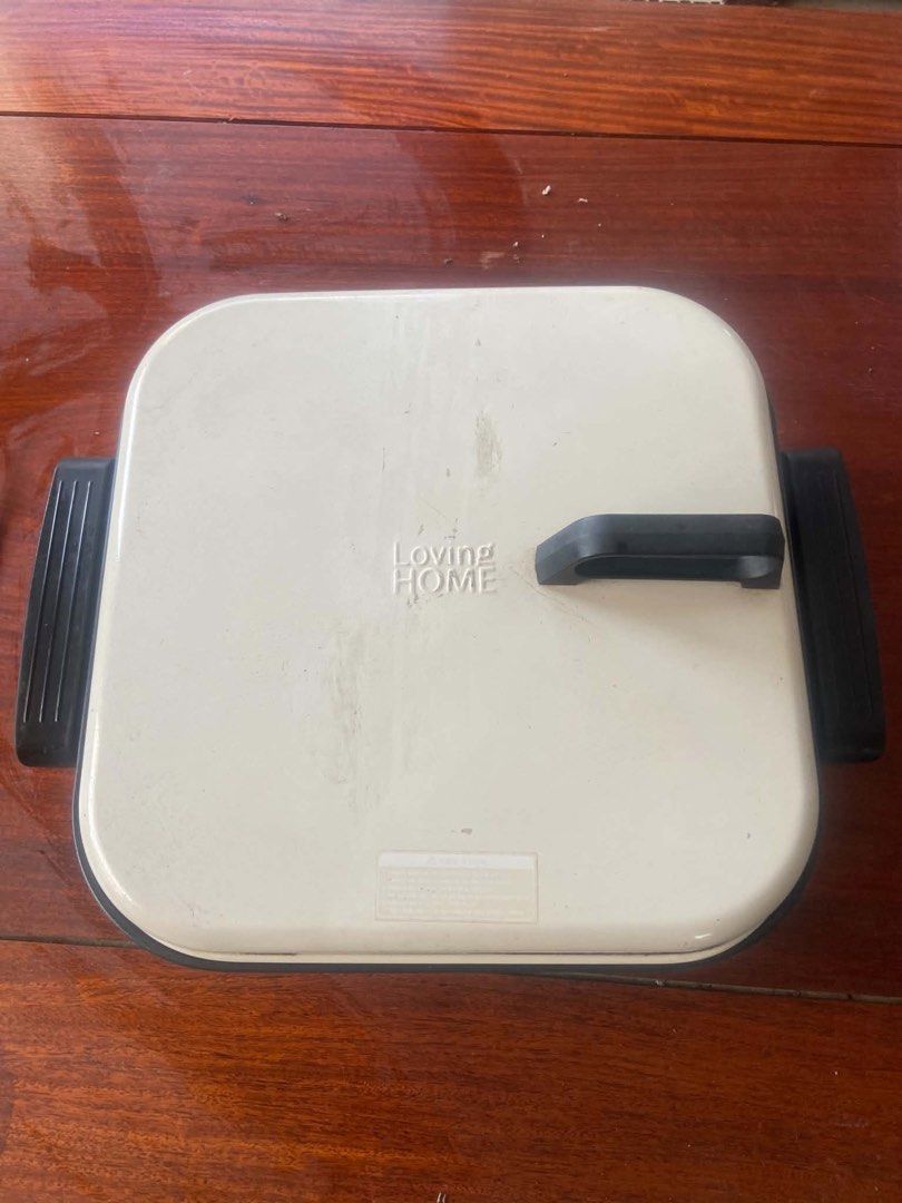 Loving Home Electric Griddle (Category: Cookware & Accessories) located in Apalit. Submitted by aclyd (Listing ID 1438995190, Image 1). Description: - Loving Home electric griddle - Square shape - Includes lid and handles - Features a black base and cream-colored top - In good working condition - Ready for your kitchen!.