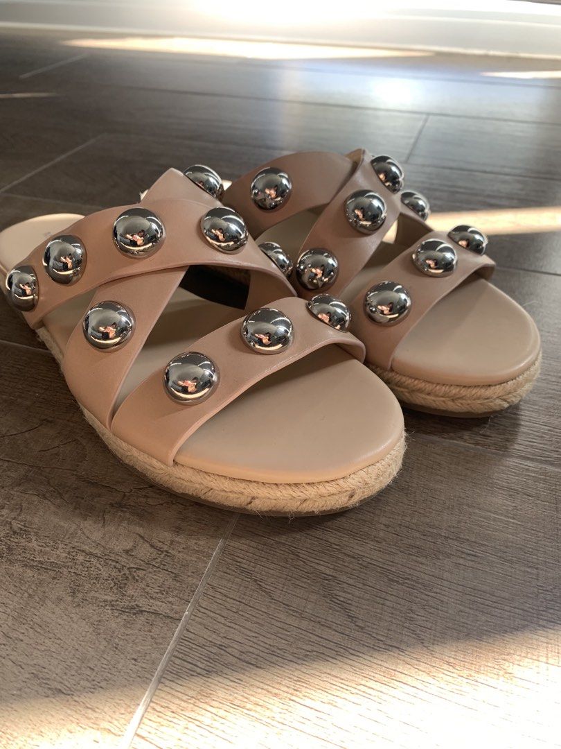 Marc Fisher Studded Sandals (Category: Flats & Sandals) located in Makati City. Submitted by mrs.k.see (Listing ID 1438950694, Image 2). Description: - Nude sandals with silver stud embellishments - Stylish criss-cross strap design - Features a woven sole - Perfect for adding flair to any outfit.