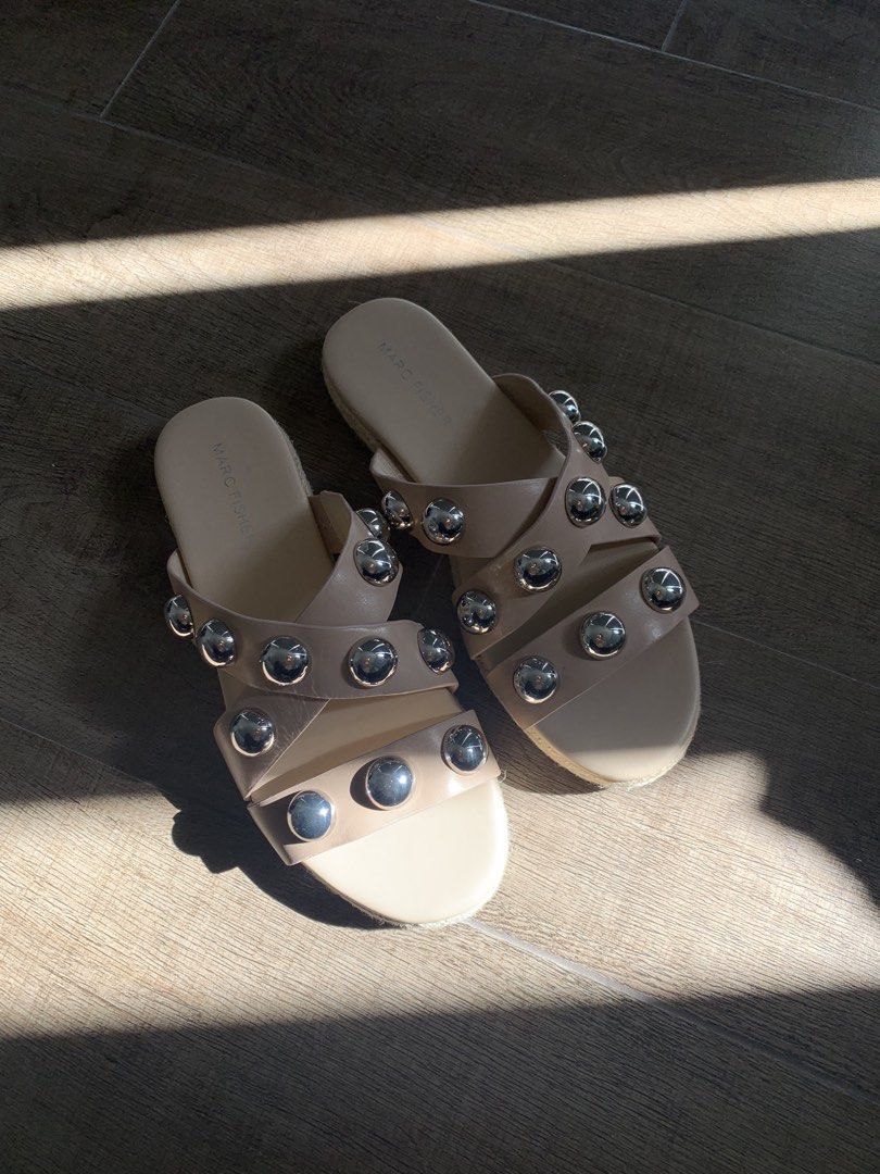 Marc Fisher Studded Sandals (Category: Flats & Sandals) located in Makati City. Submitted by mrs.k.see (Listing ID 1438950694, Image 1). Description: - Nude sandals with silver stud embellishments - Stylish criss-cross strap design - Features a woven sole - Perfect for adding flair to any outfit.