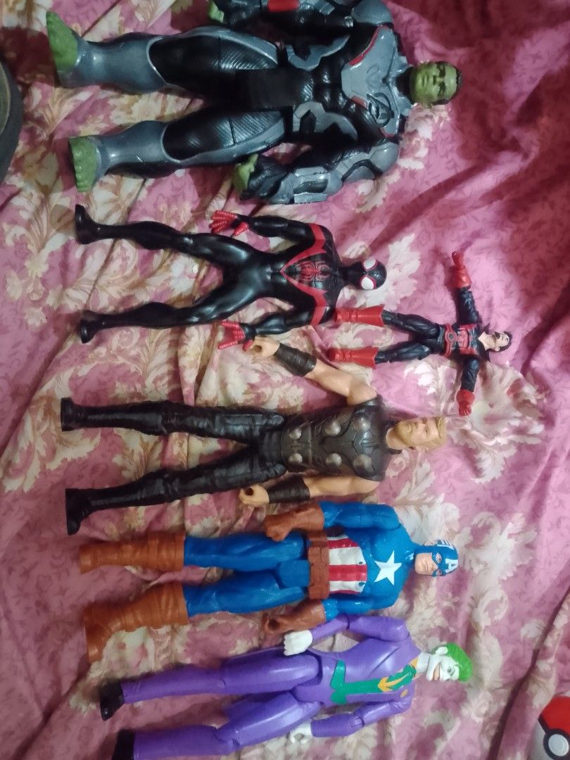 Marvel and DC Action Figures (Category: Toys & Games) located in Manila. Submitted by grasya1985 (Listing ID 1438904765, Image 1). Description: 600 pesos all - Marvel and DC action figure collection. - Characters include: Hulk, Miles Morales, Iron Man, Thor, Captain America, and The Joker. - The Joker figure features purple and green hair. - Hulk figure has grey and black armor. - Figures are in various action poses..