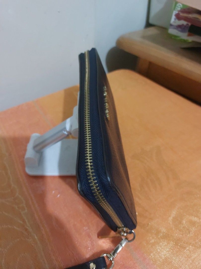 Michael Kors Continental Wristlet Navy Blue (Category: Wallets & Card holders) located in Las Pinas. Submitted by jmproperties (Listing ID 1438919572, Image 3). Description: - Authentic Michael Kors wristlet - Navy blue color - Zip-around closure - Multiple card slots - Clear ID window - Includes wrist strap - MK logo on front and zipper pull.