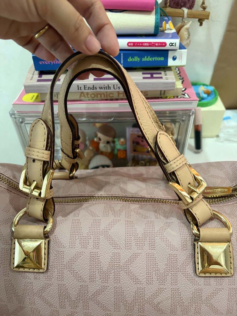 Michael Kors Pink Satchel Handbag (Category: Luxury Bags & Wallets) located in Calamba. Submitted by michCM (Listing ID 1438962071, Image 3). Description: - Michael Kors pink satchel handbag - Zip closure - Dual top handles - Gold-tone hardware - MK logo pattern - Detachable MK logo charm - Minor wear on corners - Not smooth Zipper .