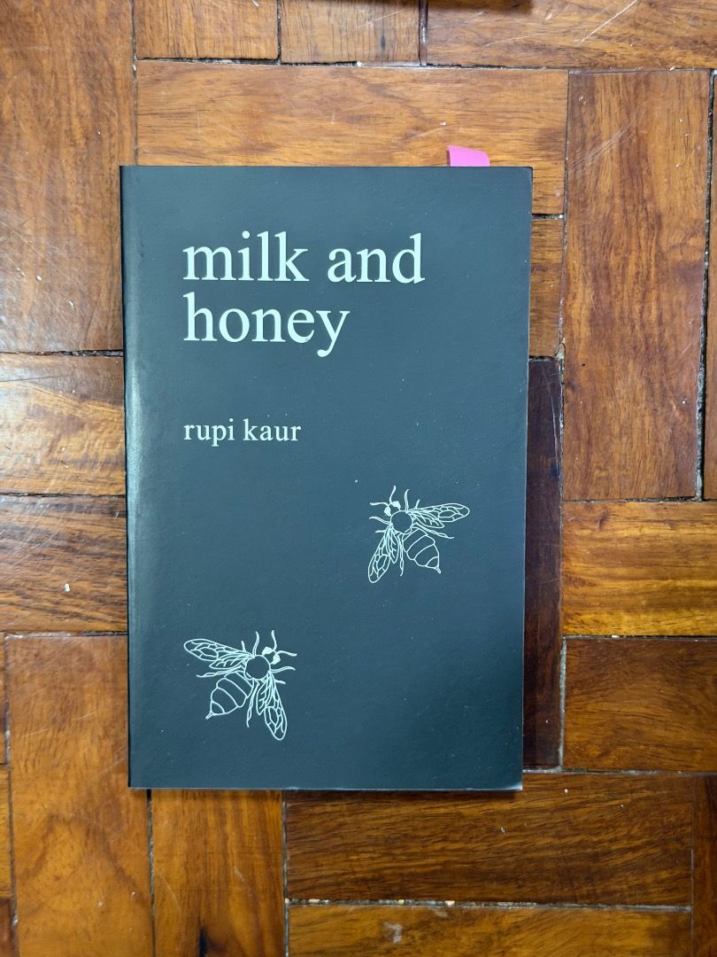Milk and Honey by Rupi Kaur (Category: Storybooks) located in Manila. Submitted by creamsandnudes (Listing ID 1438991696, Image 1). Description: - Milk and Honey by Rupi Kaur - Features a black cover with white title and author text - Includes bee illustrations - Comes with a pink bookmark.