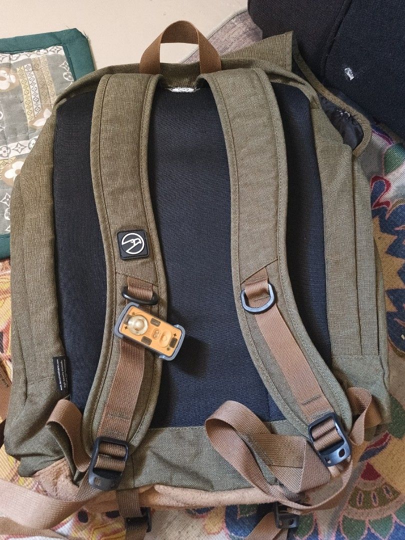 Mountaineer Backpack (Category: Backpacks) located in Taguig. Submitted by cristinevm56163 (Listing ID 1438955590, Image 2). Description: - Durable Mountaineer backpack in olive green - Multiple compartments: main and front flap pocket - Adjustable straps for a comfortable fit - Padded back panel for added comfort - Convenient top handle - Secure buckle closure - Features a small logo patch - Interior lined with black fabric.