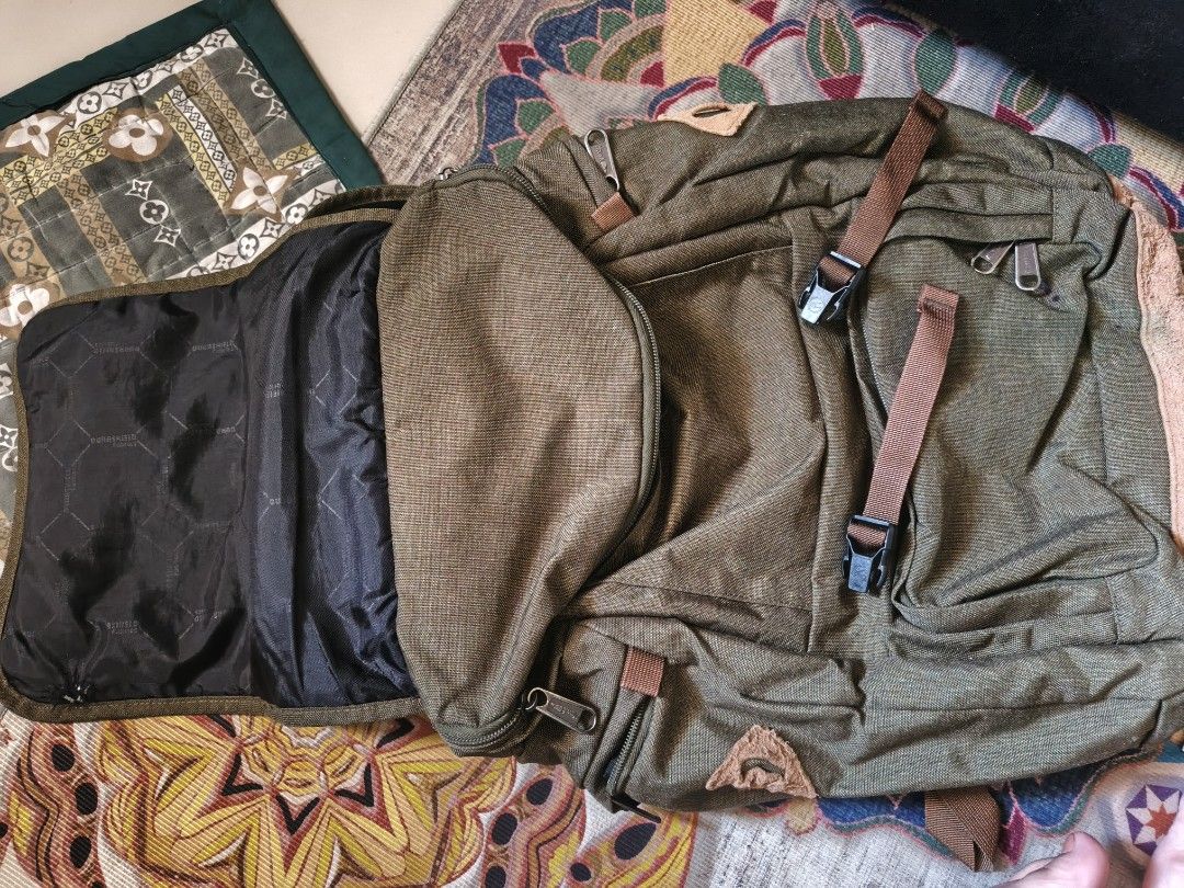 Mountaineer Backpack (Category: Backpacks) located in Taguig. Submitted by cristinevm56163 (Listing ID 1438955590, Image 3). Description: - Durable Mountaineer backpack in olive green - Multiple compartments: main and front flap pocket - Adjustable straps for a comfortable fit - Padded back panel for added comfort - Convenient top handle - Secure buckle closure - Features a small logo patch - Interior lined with black fabric.