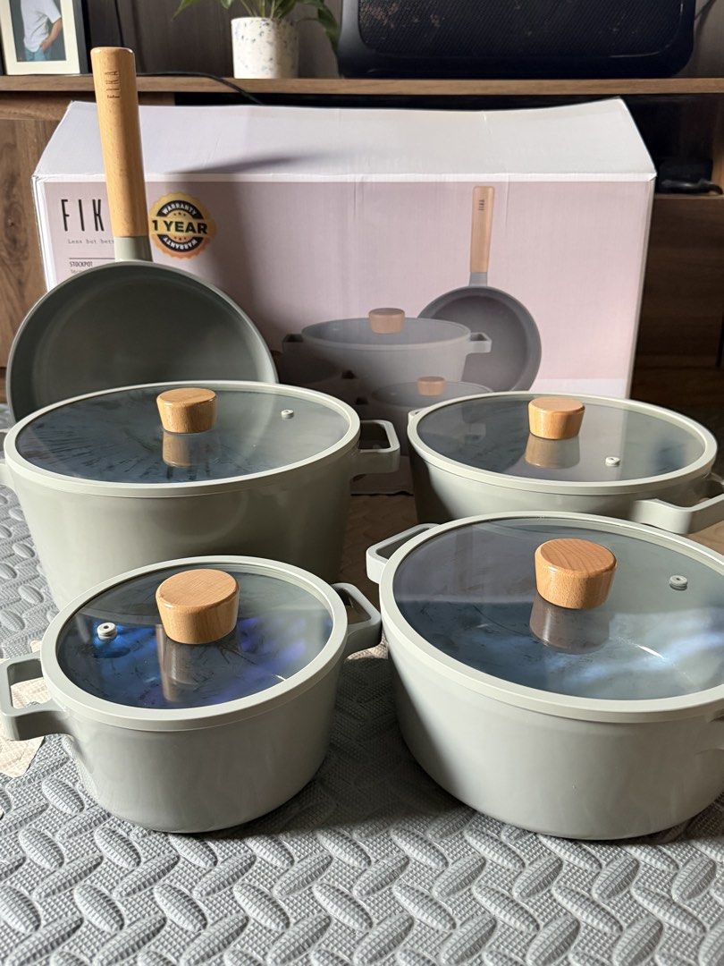 Neoflam Fika Cookware Set (Category: Cookware & Accessories) located in Quezon City. Submitted by eckaaatxn (Listing ID 1438958868, Image 2). Description: - Complete Fika cookware set - Light grey color - Wooden handles and knobs - Includes pots, pans, and lids - Brand new, in original packaging - Made in Korea.