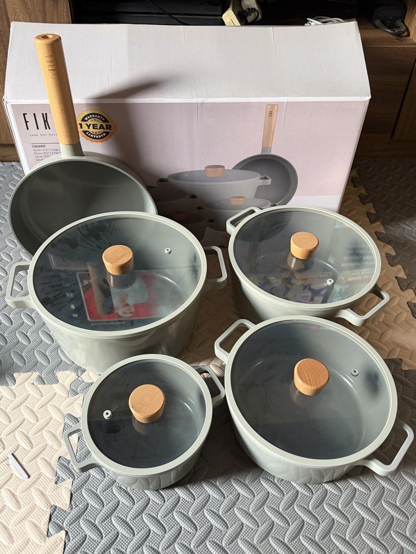 Neoflam Fika Cookware Set (Category: Cookware & Accessories) located in Quezon City. Submitted by eckaaatxn (Listing ID 1438958868, Image 1). Description: - Complete Fika cookware set - Light grey color - Wooden handles and knobs - Includes pots, pans, and lids - Brand new, in original packaging - Made in Korea.