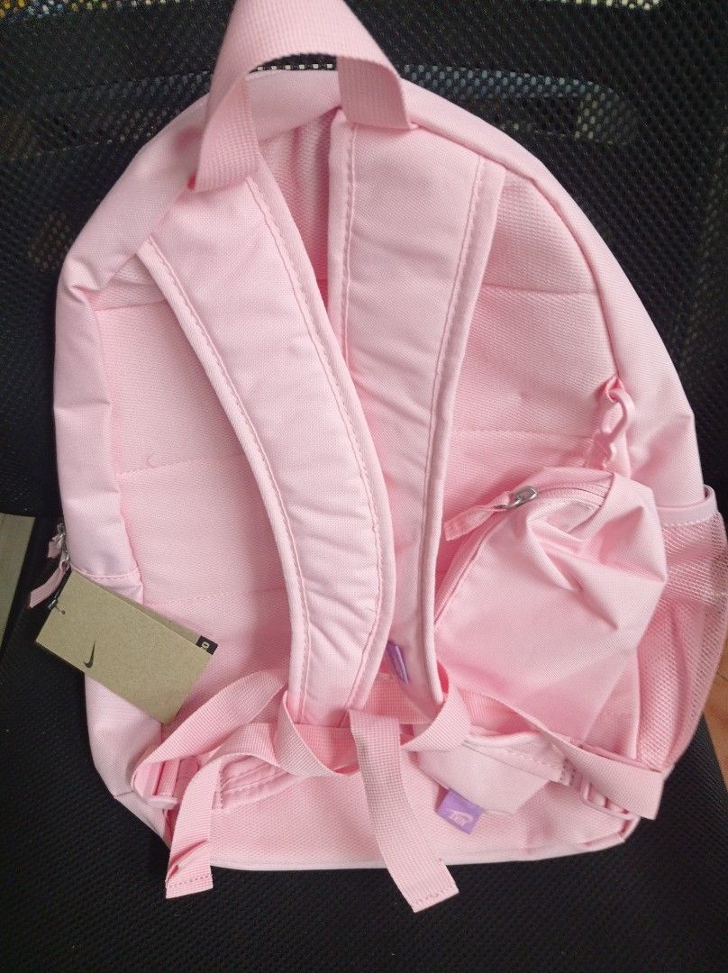 Nike Backpack 20L Pink Grade School with free Pencil case (Category: Backpacks) located in Manila. Submitted by kamirphili04754 (Listing ID 1438981910, Image 2). Description: - Nike backpack in a striking pink color. - Features the classic Nike logo. - Includes a spacious main compartment. - Has a front zippered pocket for easy access. - Equipped with side mesh pockets for water bottles. - Features a small zippered pouch on the back. - 20L capaci