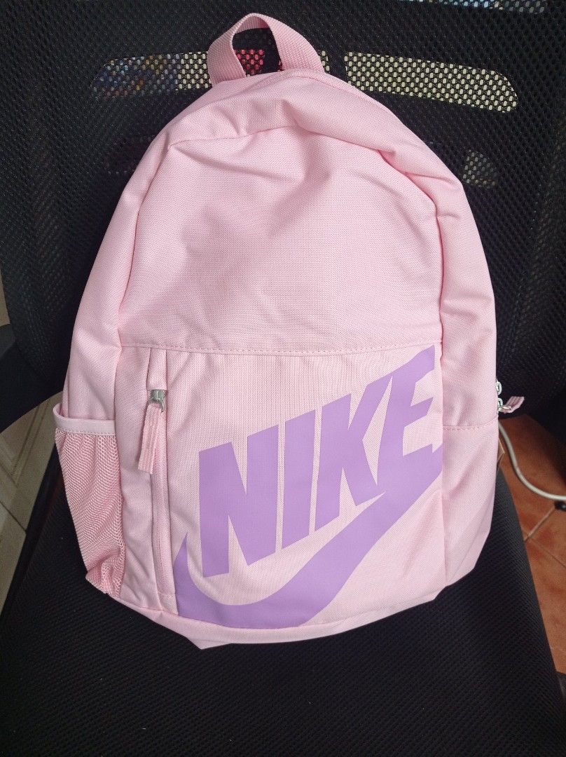 Nike Backpack 20L Pink Grade School with free Pencil case (Category: Backpacks) located in Manila. Submitted by kamirphili04754 (Listing ID 1438981910, Image 1). Description: - Nike backpack in a striking pink color. - Features the classic Nike logo. - Includes a spacious main compartment. - Has a front zippered pocket for easy access. - Equipped with side mesh pockets for water bottles. - Features a small zippered pouch on the back. - 20L capaci