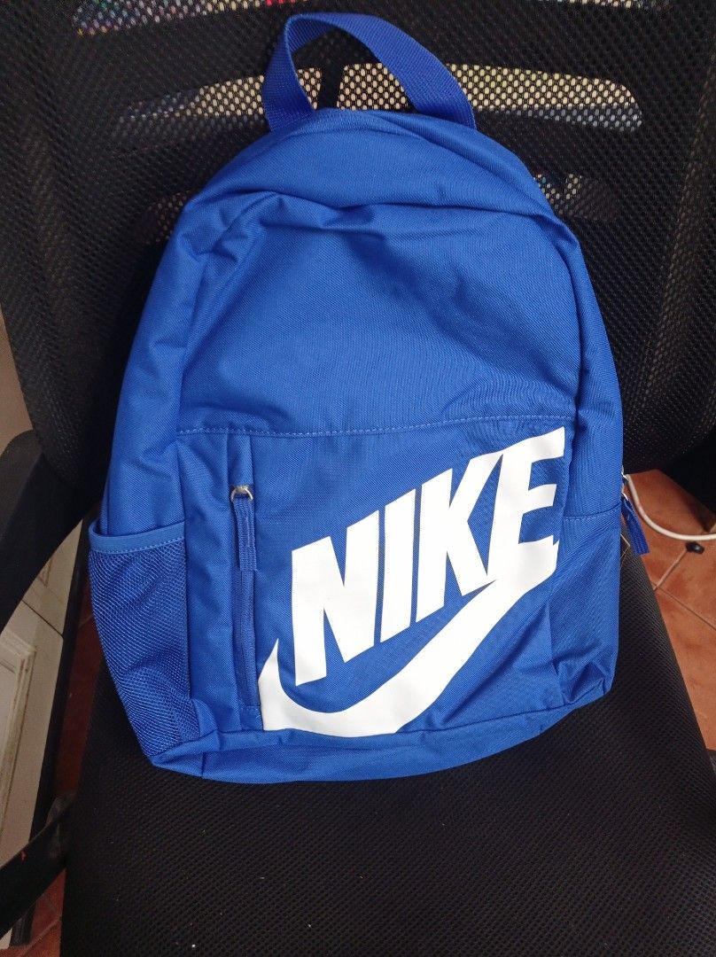 Nike Backpack - Blue Grade School with free Pencil Case (Category: Backpacks) located in Manila. Submitted by kamirphili04754 (Listing ID 1438981473, Image 2). Description: - Nike backpack in a striking blue color. - Features the classic Nike logo. - Includes a spacious main compartment. - Has a front zippered pocket for easy access. - Equipped with side mesh pockets for water bottles. - Features a small zippered pouch on the back. - 20L capacity