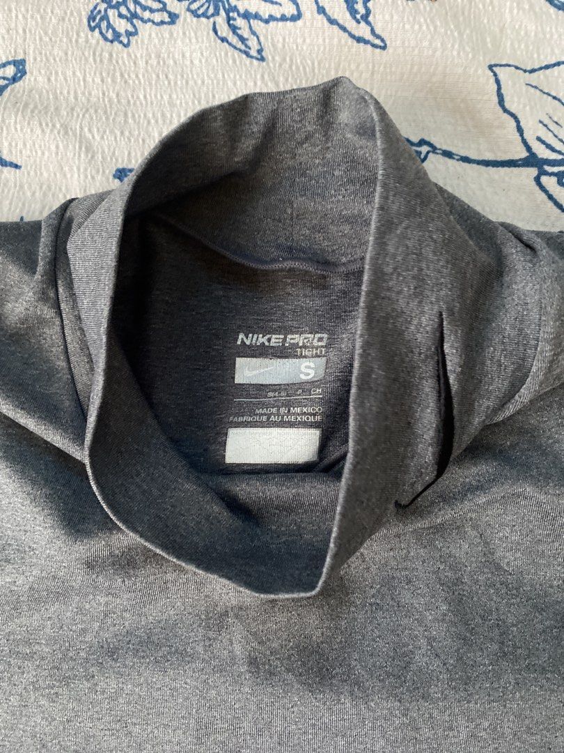 Nike Pro Tight Long Sleeve Shirt (Category: Activewear) located in Davao. Submitted by _belalua (Listing ID 1438906317, Image 2). Description: - Nike Pro Tight long sleeve shirt - Color: Gray - Size: S - Features a mock neck - Equipped with Nike Fit technology - Small Nike logo on the neck.