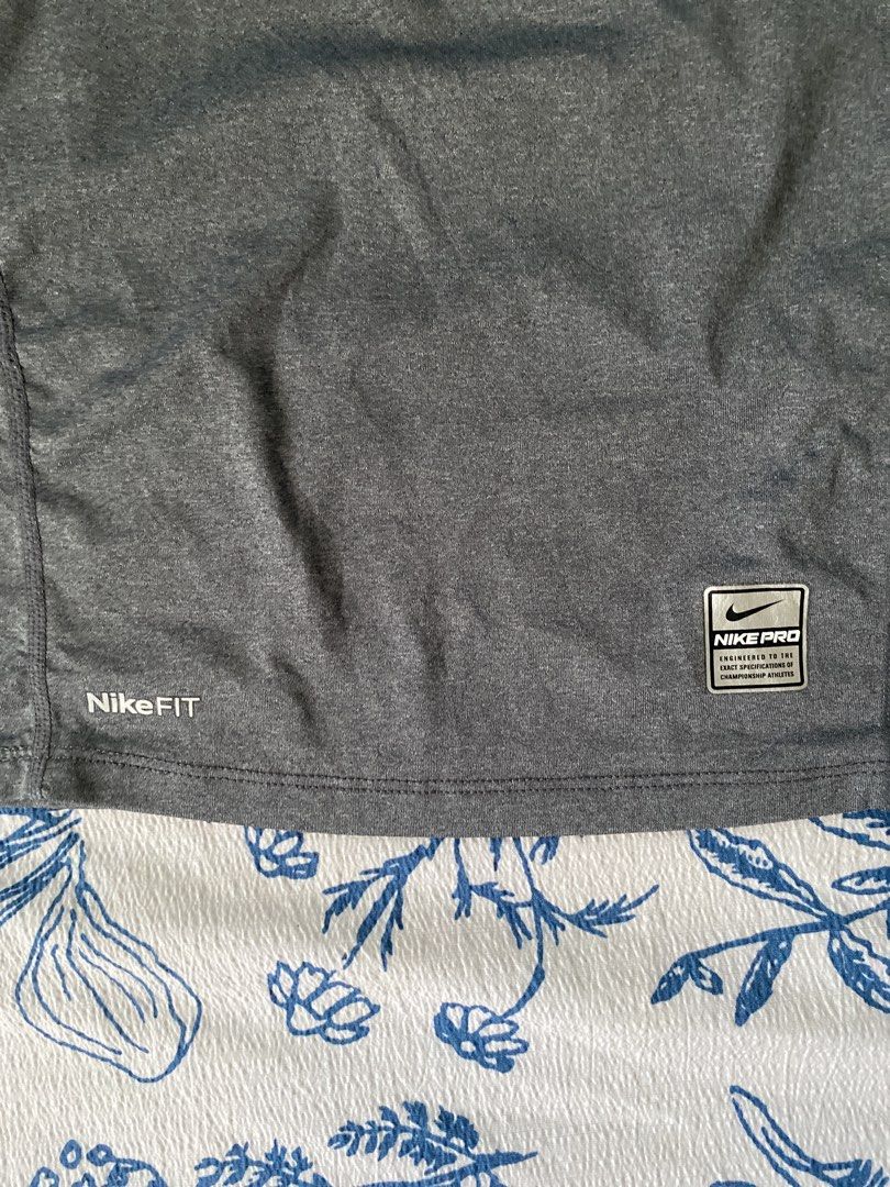 Nike Pro Tight Long Sleeve Shirt (Category: Activewear) located in Davao. Submitted by _belalua (Listing ID 1438906317, Image 3). Description: - Nike Pro Tight long sleeve shirt - Color: Gray - Size: S - Features a mock neck - Equipped with Nike Fit technology - Small Nike logo on the neck.