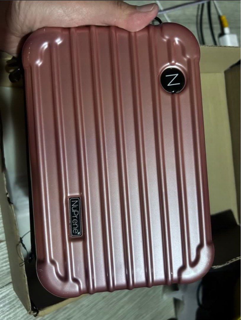 NuPrene Mini Cosmetic Case with Strap (Category: Purses & Pouches) located in Manila. Submitted by emsmerize (Listing ID 1439027496, Image 2). Description: - NuPrene mini cosmetic case - Ideal for travel - Hard shell exterior in rose color - Black zipper - Black strap with NuPrene logo - Interior mesh pocket for organization - Includes original box.