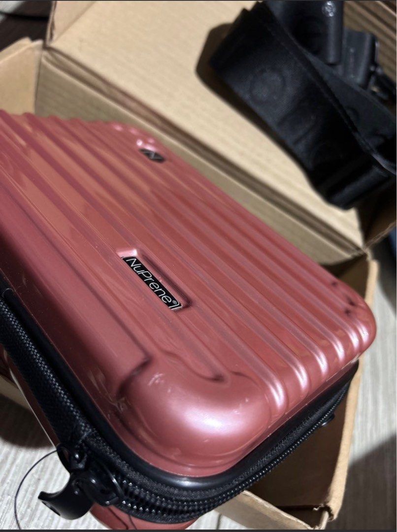NuPrene Mini Cosmetic Case with Strap (Category: Purses & Pouches) located in Manila. Submitted by emsmerize (Listing ID 1439027496, Image 1). Description: - NuPrene mini cosmetic case - Ideal for travel - Hard shell exterior in rose color - Black zipper - Black strap with NuPrene logo - Interior mesh pocket for organization - Includes original box.