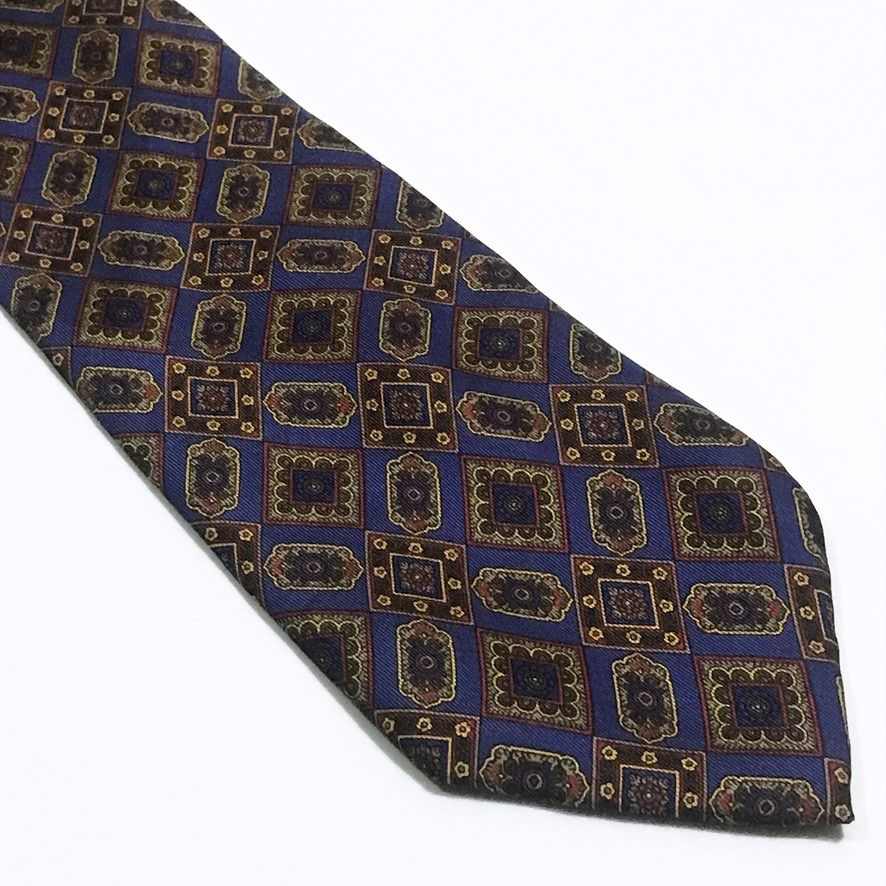 Philippe de Villiere Ornate Pattern Deep Navy Neck Tie (Category: Ties) located in Taguig. Submitted by retrogaze (Listing ID 1438917735, Image 3). Description: This Philippe de Villiere necktie is elegantly crafted from 100% silk, featuring a rich deep navy blue base with a smooth, luxurious finish. The tie is adorned with a detailed and ornate geometric pattern composed of miniature interlocking diamonds and medallions in a refined palette of c