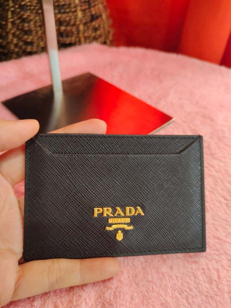 Prada Card Holder (Category: Luxury Bags & Wallets) located in Cebu City. Submitted by tlisurplus (Listing ID 1439020717, Image 1). Description: - Authentic Prada card holder - Color: Black - Features the gold Prada logo - Made in Italy - Sleek leather design - Multiple card slots.