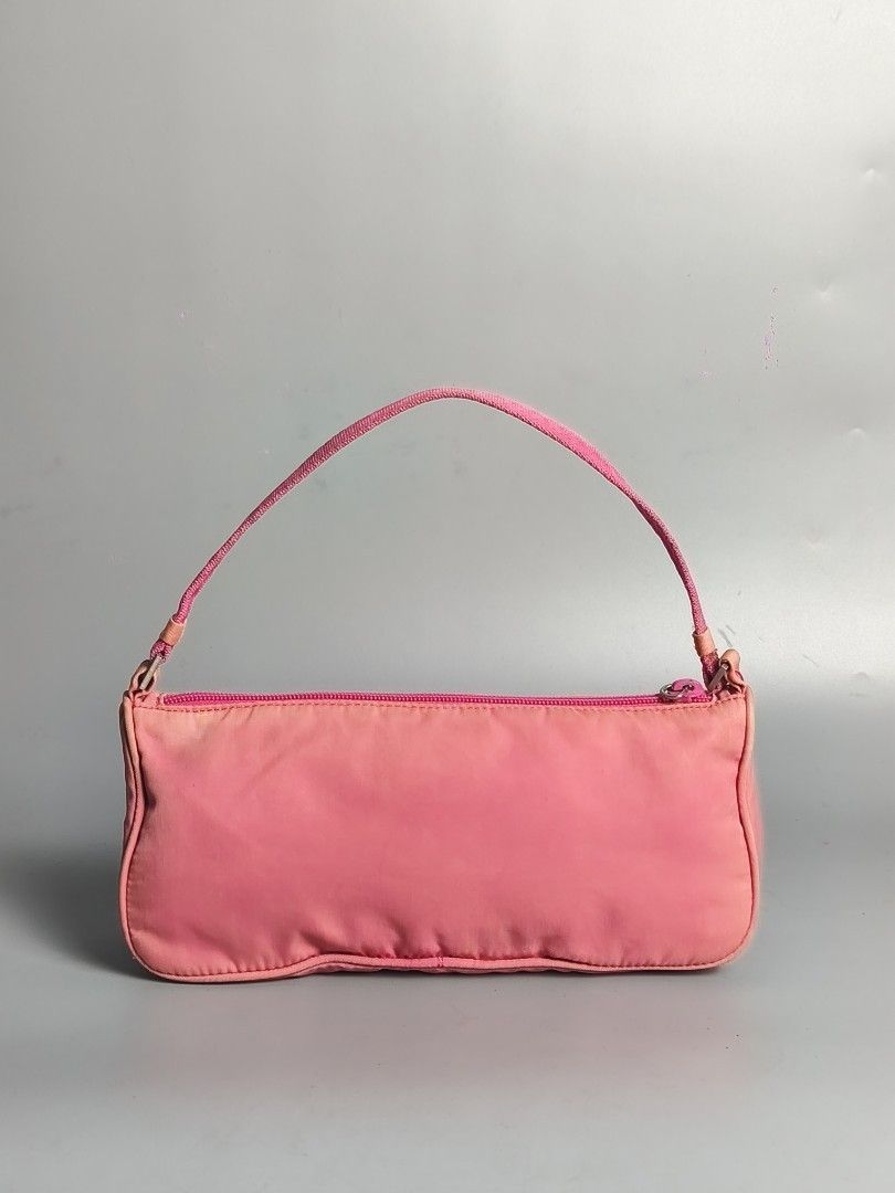 Prada Tessuto Nylon Pink Pochette Bag (Category: Luxury Bags & Wallets) located in Bulacan. Submitted by 4kcollection.ph (Listing ID 1438968507, Image 2). Description: Prada Tessuto Nylon Pink Pochette Bag Pre-loved from Japan 🇯🇵 Good Condition (8.5/10) Size: Small Opti Zip Code fade Missing puller No Major issue Dm for sure buyer 📩 MOP: Gcash / Maya / BPI Courier: J&t / Lbc / Lalamove Location: SJDM Bulacan.