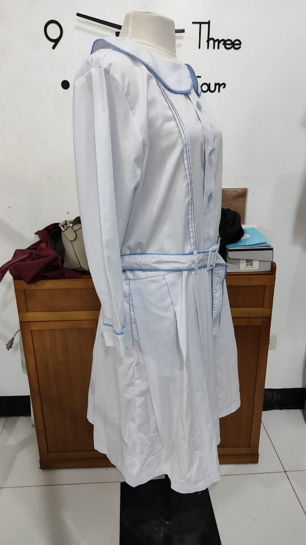 Preloved Marikina Catholic Gala Uniform (XL) (Category: Dresses) located in Antipolo. Submitted by whatshopdude (Listing ID 1439001043, Image 3). Description: Preloved Marikina Catholic Gala Uniform (XL) - White dress with Peter Pan collar - Long sleeves - Blue trim on collar, cuffs, and belt - Matching belt with white buckle - Button-down front - Pleated skirt - Vintage/retro style.