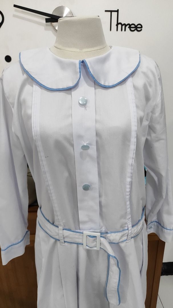 Preloved Marikina Catholic Gala Uniform (XL) (Category: Dresses) located in Antipolo. Submitted by whatshopdude (Listing ID 1439001043, Image 2). Description: Preloved Marikina Catholic Gala Uniform (XL) - White dress with Peter Pan collar - Long sleeves - Blue trim on collar, cuffs, and belt - Matching belt with white buckle - Button-down front - Pleated skirt - Vintage/retro style.