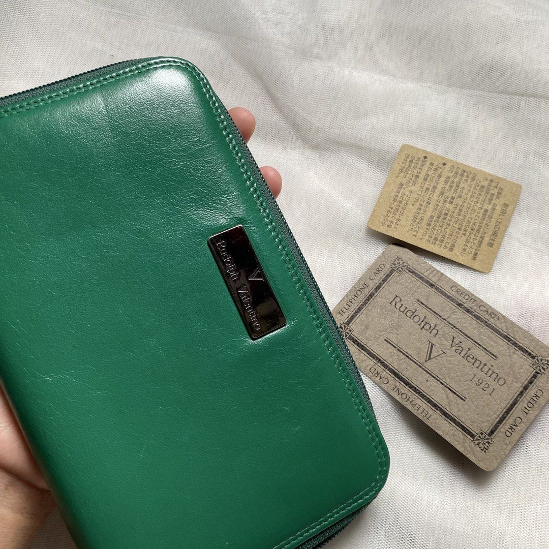 Rudolph Valentino Green Wallet (Category: Luxury Bags & Wallets) located in Makati City. Submitted by imsuli (Listing ID 1438945860, Image 3). Description: ෆ Authentic ෆ Color: Vibrant Green ෆ Features: Zip-around closure ෆ Interior: Multiple compartments, card slots, zippered coin pocket ෆ Exterior: Silver-tone brand plate.