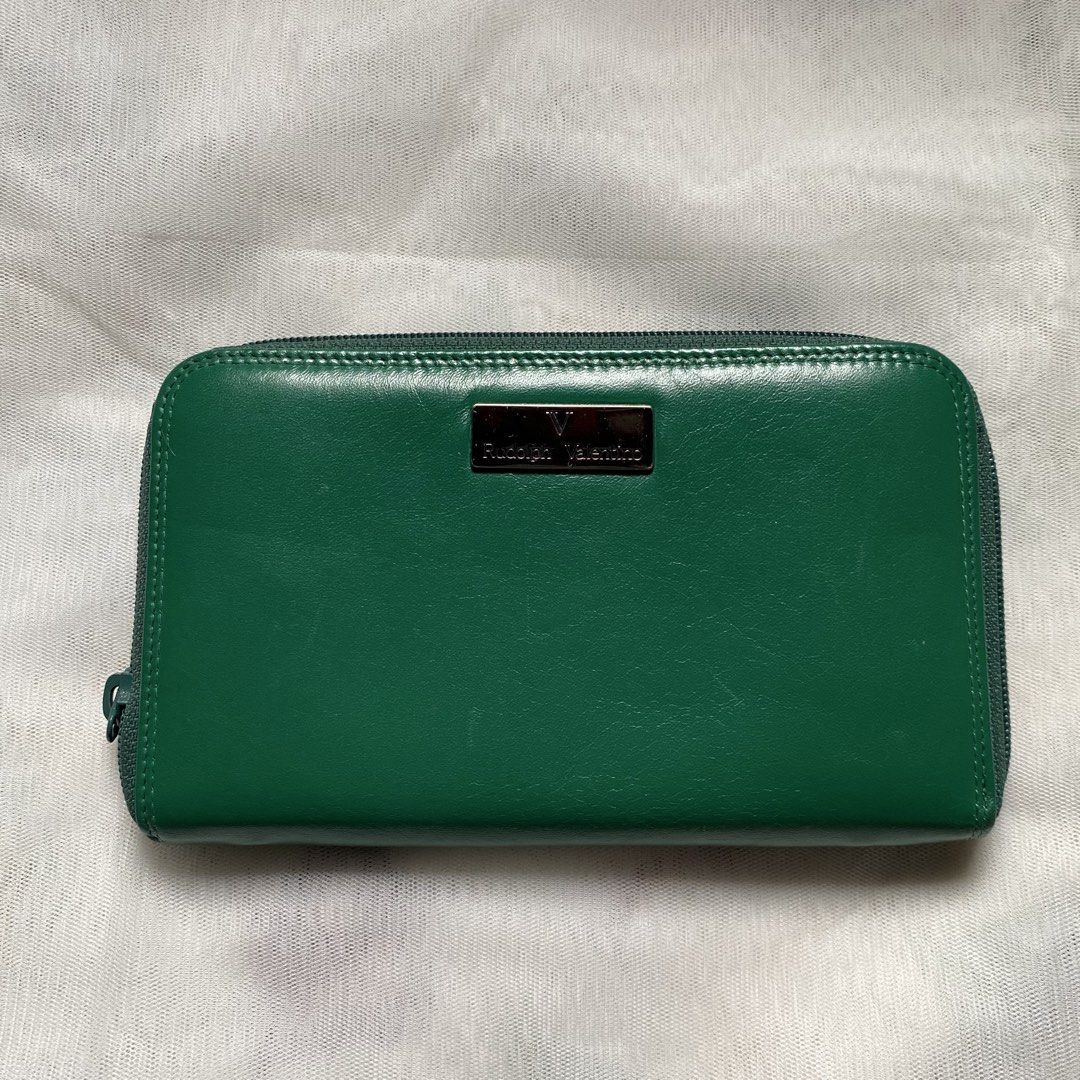 Rudolph Valentino Green Wallet (Category: Luxury Bags & Wallets) located in Makati City. Submitted by imsuli (Listing ID 1438945860, Image 1). Description: ෆ Authentic ෆ Color: Vibrant Green ෆ Features: Zip-around closure ෆ Interior: Multiple compartments, card slots, zippered coin pocket ෆ Exterior: Silver-tone brand plate.