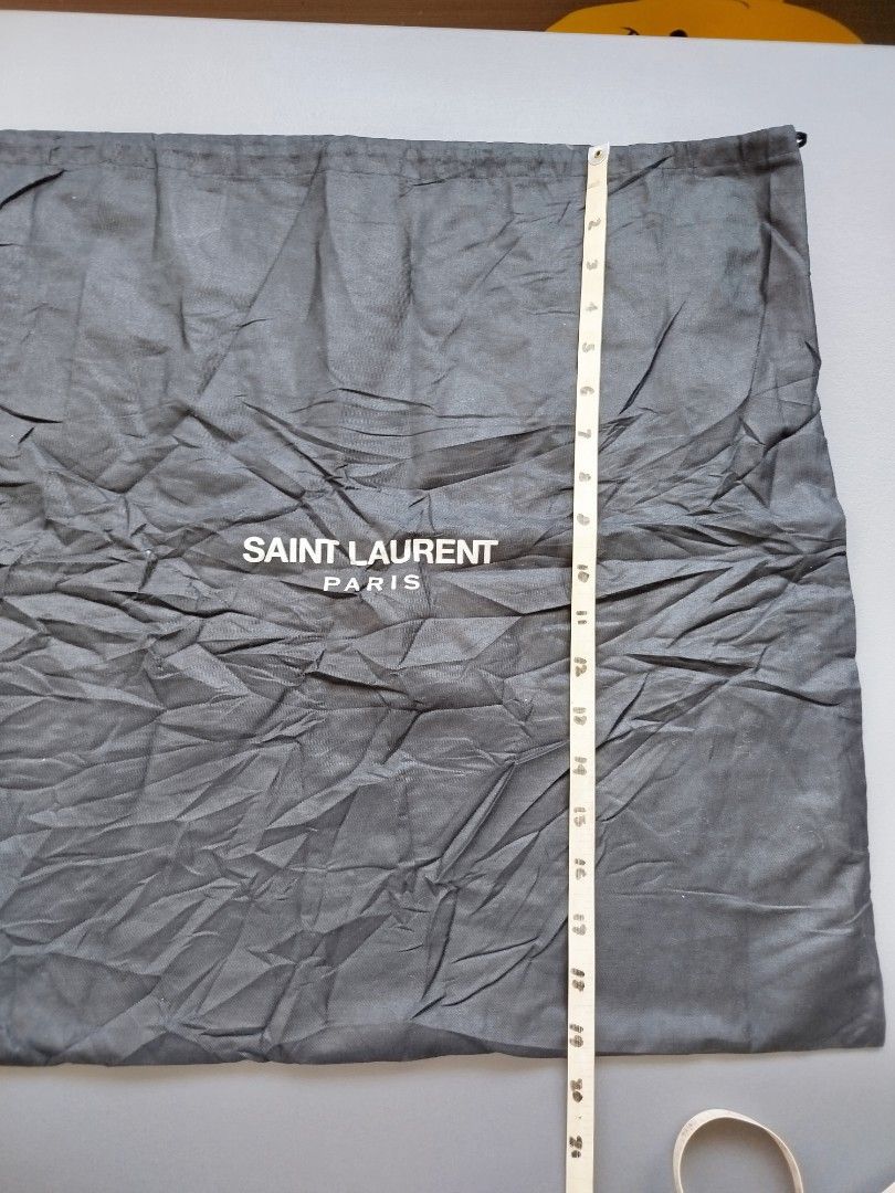 Saint Laurent Dust Bag (Category: Luxury Bags & Wallets) located in Calamba. Submitted by merrymerida (Listing ID 1438914698, Image 2). Description: - Authentic Saint Laurent dust bag - Features the Saint Laurent Paris logo - Made in Italy - Color: Gray - Condition: Good - Size: Approximately 20 inches long - Ideal for protecting luxury items.