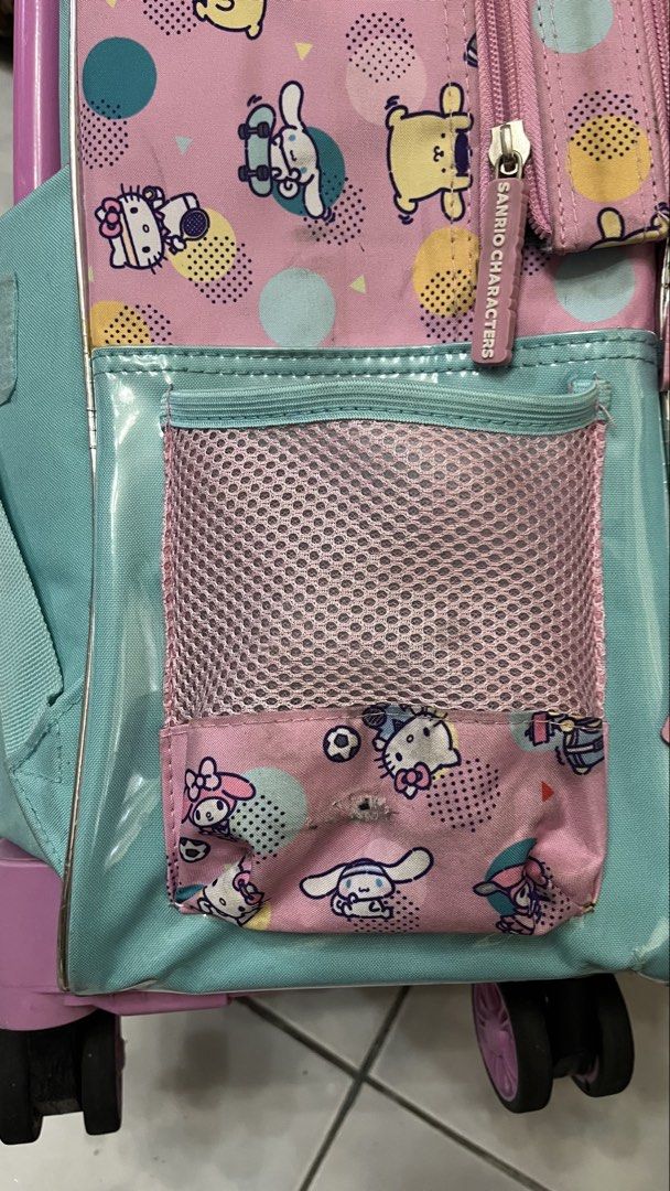 Sanrio Characters Rolling Backpack (Category: Strollers) located in San Pedro. Submitted by silvermist_f1 (Listing ID 1438934327, Image 3). Description: - Sanrio rolling backpack with lunch bag - Features Kitty, Cinnamoroll, and My Melody. - Multiple compartments for storage. - Includes a front pocket with a mesh section and a side pocket. - Easy to transport with a retractable handle and wheels. - With bag cover Used but still cute and functiona