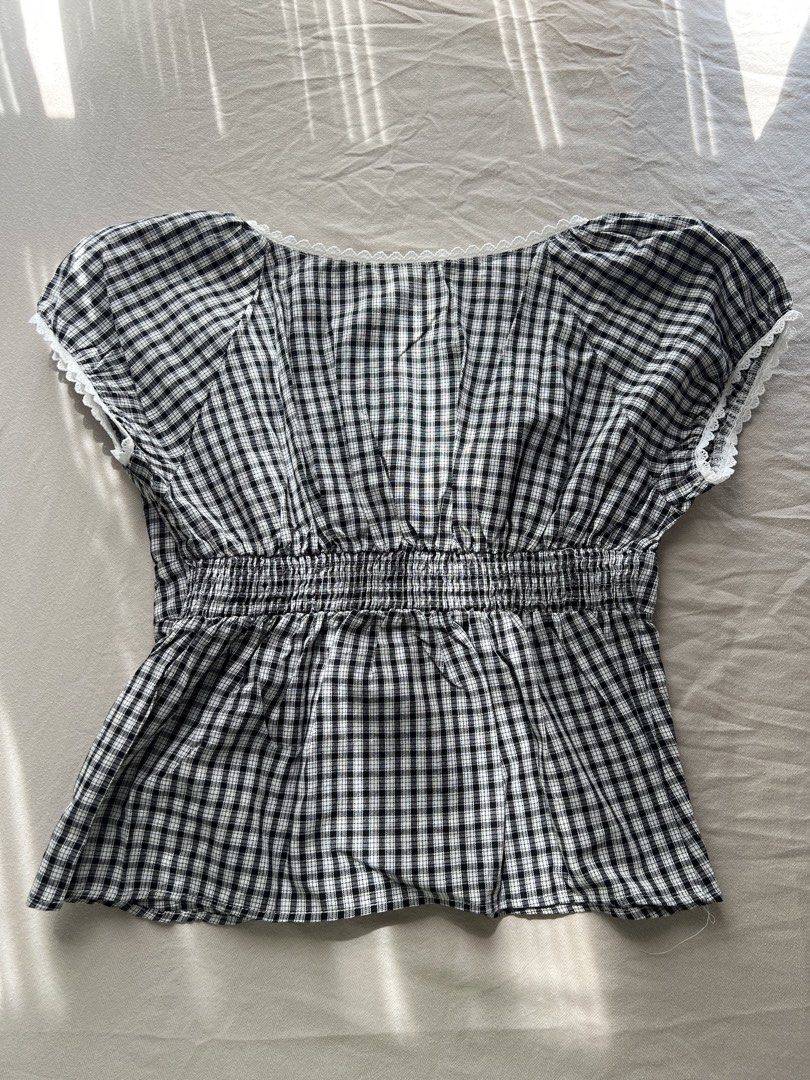 Shein Gingham Top with Lace Trim (Category: Sleeveless) located in Cabuyao City. Submitted by declutter_w_mee (Listing ID 1438886062, Image 2). Description: - Shein gingham top - Features delicate lace trim - Square neckline - Button-down front - Short sleeves - Fitted waist - Comfortable cotton-viscose blend - Suitable for various occasions.