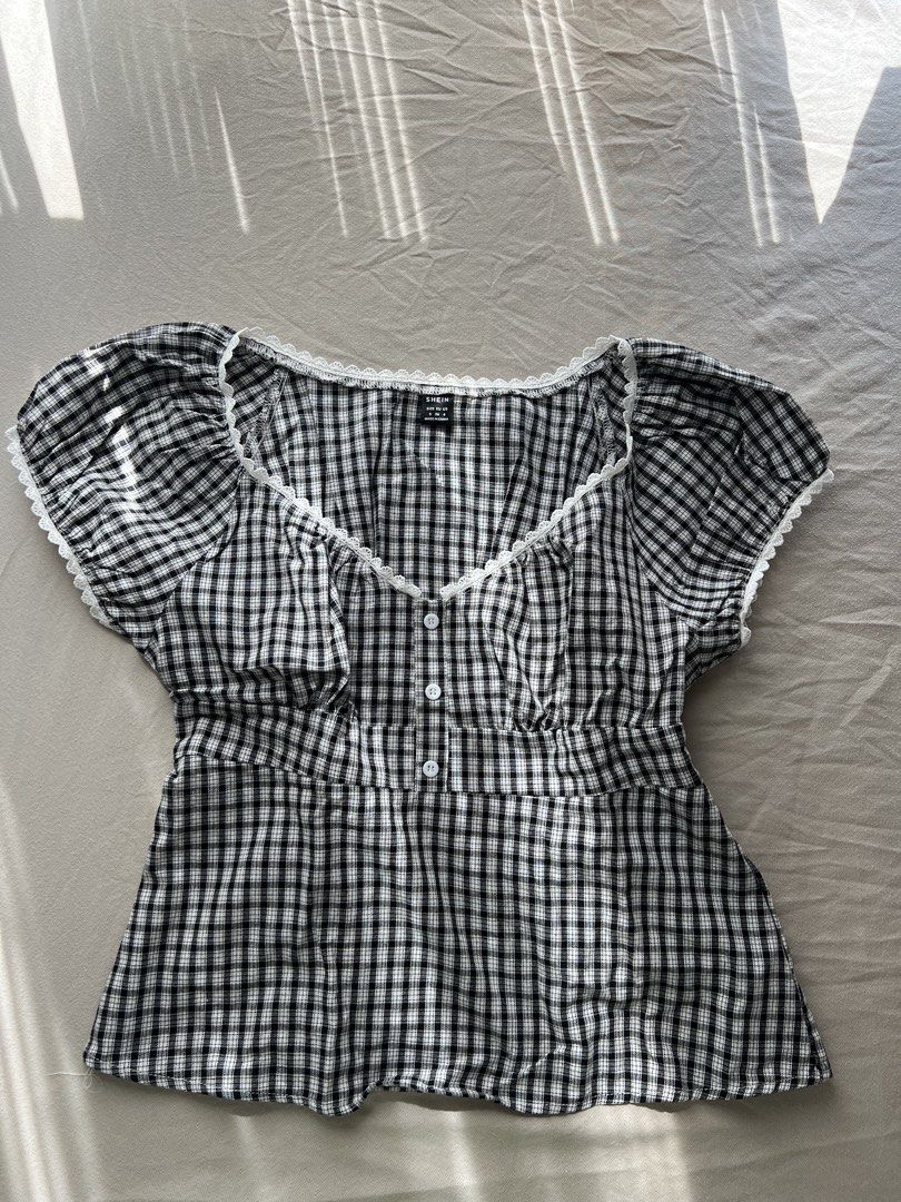 Shein Gingham Top with Lace Trim (Category: Sleeveless) located in Cabuyao City. Submitted by declutter_w_mee (Listing ID 1438886062, Image 1). Description: - Shein gingham top - Features delicate lace trim - Square neckline - Button-down front - Short sleeves - Fitted waist - Comfortable cotton-viscose blend - Suitable for various occasions.