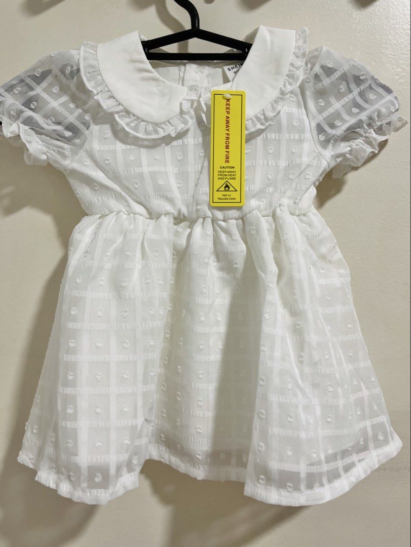 SHEIN White Dress 3-6M (Category: Babies & Kids Fashion) located in San Fernando. Submitted by hey_just (Listing ID 1438941278, Image 2). Description: - SHEIN baby dress - Size: 3-6 months - Color: White - Features a Peter Pan collar - Short, puffy sleeves - Textured checkered pattern - Buttons at the back - Stylish and sweet design - Good for Baptism RFS: bought it expecting i’ll have a niece, turns out..it’s a nephew. .