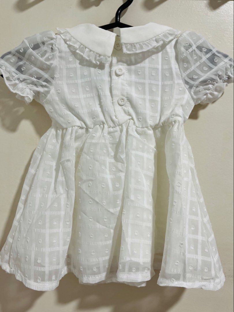 SHEIN White Dress 3-6M (Category: Babies & Kids Fashion) located in San Fernando. Submitted by hey_just (Listing ID 1438941278, Image 3). Description: - SHEIN baby dress - Size: 3-6 months - Color: White - Features a Peter Pan collar - Short, puffy sleeves - Textured checkered pattern - Buttons at the back - Stylish and sweet design - Good for Baptism RFS: bought it expecting i’ll have a niece, turns out..it’s a nephew. .