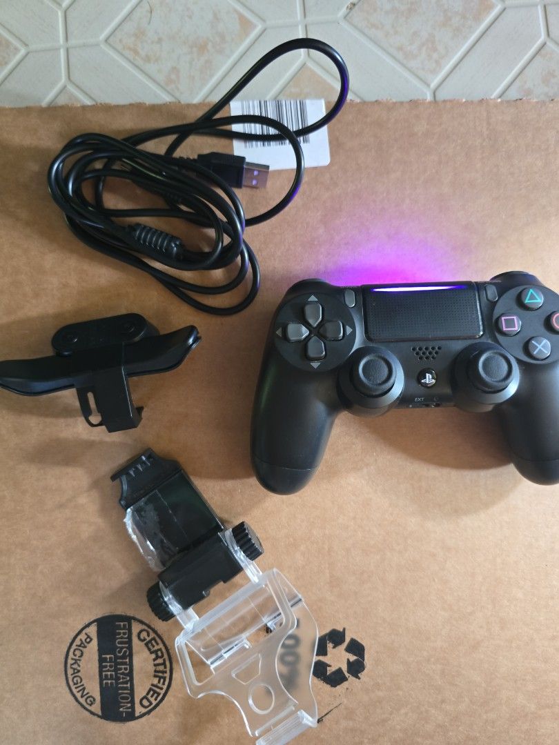 Sony PlayStation 4 DualShock 4 Controller SET (Category: Controllers) located in Infanta. Submitted by acecarrot07 (Listing ID 1438961068, Image 1). Description: - Black Sony PlayStation 4 DualShock 4 controller - Battery upgraded to 2000 mah - Includes phone clip for mobile gaming - Comes with a charging cable - Features standard button layout and touchpad - Detachable back button attachment - USB charging port - Original with factory sticker RF