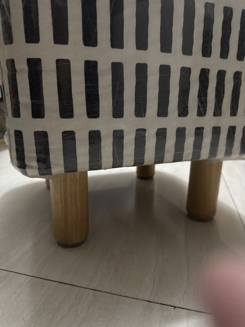 Square Footstool with Wooden Legs (Category: Chairs) located in Quezon City. Submitted by elektra0111 (Listing ID 1439000556, Image 2). Description: - Square footstool - Black and white geometric pattern - Wooden legs - Wrapped in plastic - Comfortable and functional - Perfect for resting feet or extra seating.
