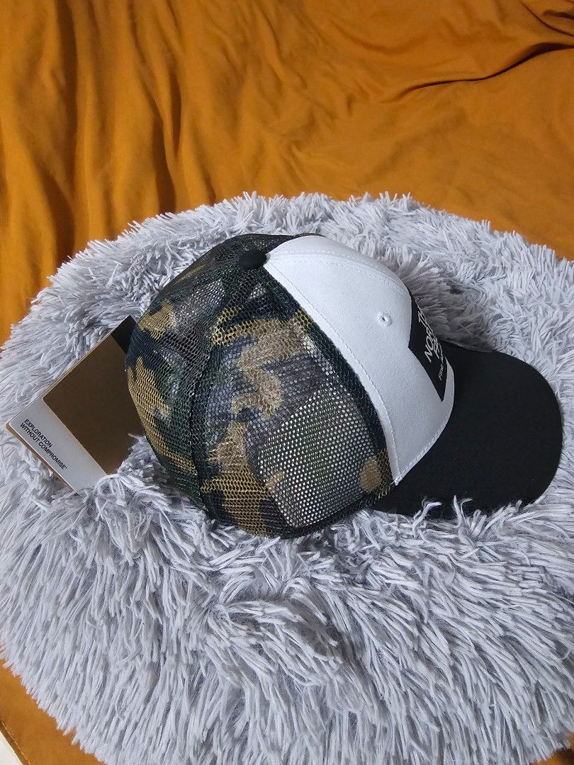 The North Face Camo Trucker Cap (Category: Caps & Hats) located in Mandaluyong City. Submitted by haneinomichi (Listing ID 1438896656, Image 2). Description: - The North Face cap - Classic trucker style - White front panel with The North Face logo - Black brim - Camo mesh back - Includes original tags - Adjustable strap for a comfortable fit - Ideal for outdoor use.
