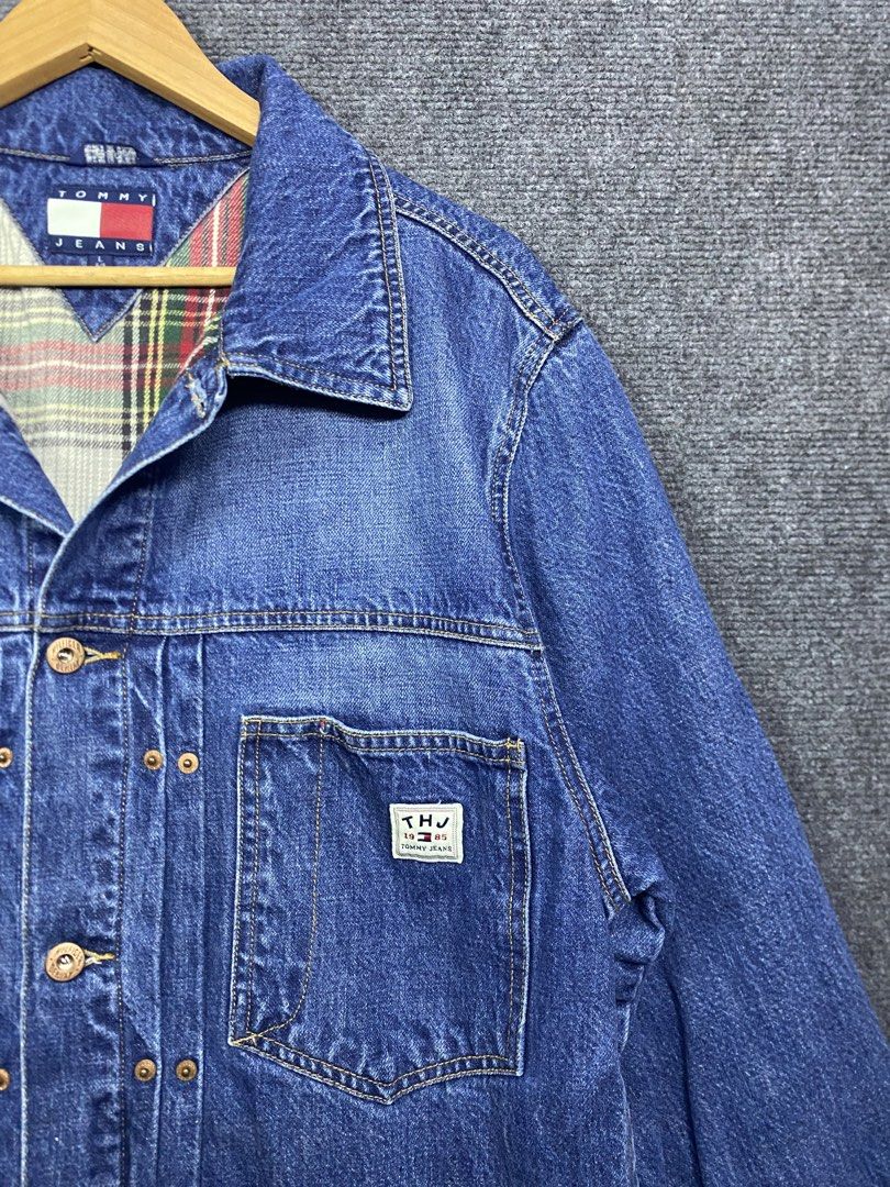 Tommy Hilfiger Plaid Denim trucker Jacket (Category: Coats, Jackets and Outerwear) located in Bolinao. Submitted by frenced28 (Listing ID 1438930170, Image 3). Description: - Authentic Tommy Hilfiger denim jacket - Size: L - Classic denim design - Button closures - Two front pockets - Plaid lining (visible at collar) - Tommy Hilfiger logo on chest pocket and inside collar.