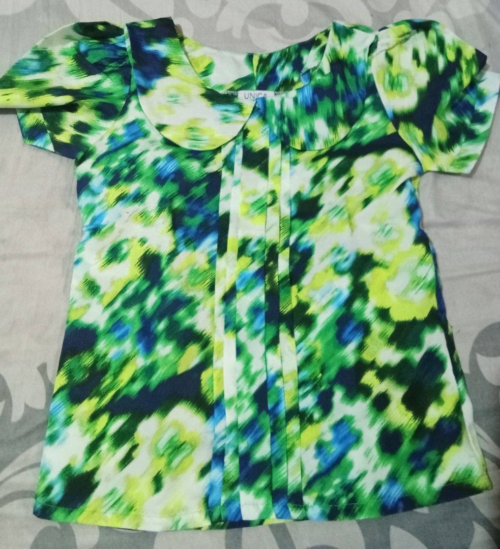 Unica Floral Top (Category: Blouses) located in Iloilo. Submitted by princessd99218 (Listing ID 1438916370, Image 1). Description: - Unica floral top - Features a vibrant floral print in green, blue, and yellow - Peter Pan collar - Short sleeves - Pleats down the front - Lightweight fabric - Ideal for warm weather.