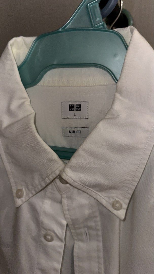 Uniqlo Slim Fit Button Down Shirt - White (Category: Tshirts & Polo Shirts ) located in Quezon City. Submitted by localthriftstore (Listing ID 1439009567, Image 3). Description: - Uniqlo button-down shirt - Color: White - Size: L - Fit: Slim - Features: Button-down collar, chest pocket - Sleeves: Long - Style: Classic, versatile - Occasion: Casual to semi-formal.