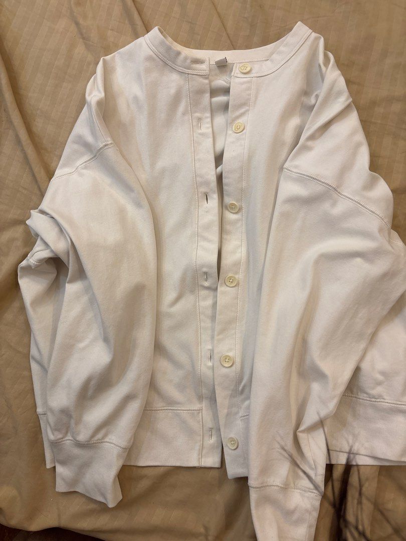 Uniqlo White Cardigan (Category: Coats, Jackets and Outerwear) located in Manila. Submitted by hanykokokoki (Listing ID 1439041631, Image 2). Description: - Uniqlo white cardigan - Round neck - Button-down closure - Made in Vietnam - Fabric: Cotton, polyester, spandex, rayon blend - Long sleeves - Relaxed fit - Great for layering.