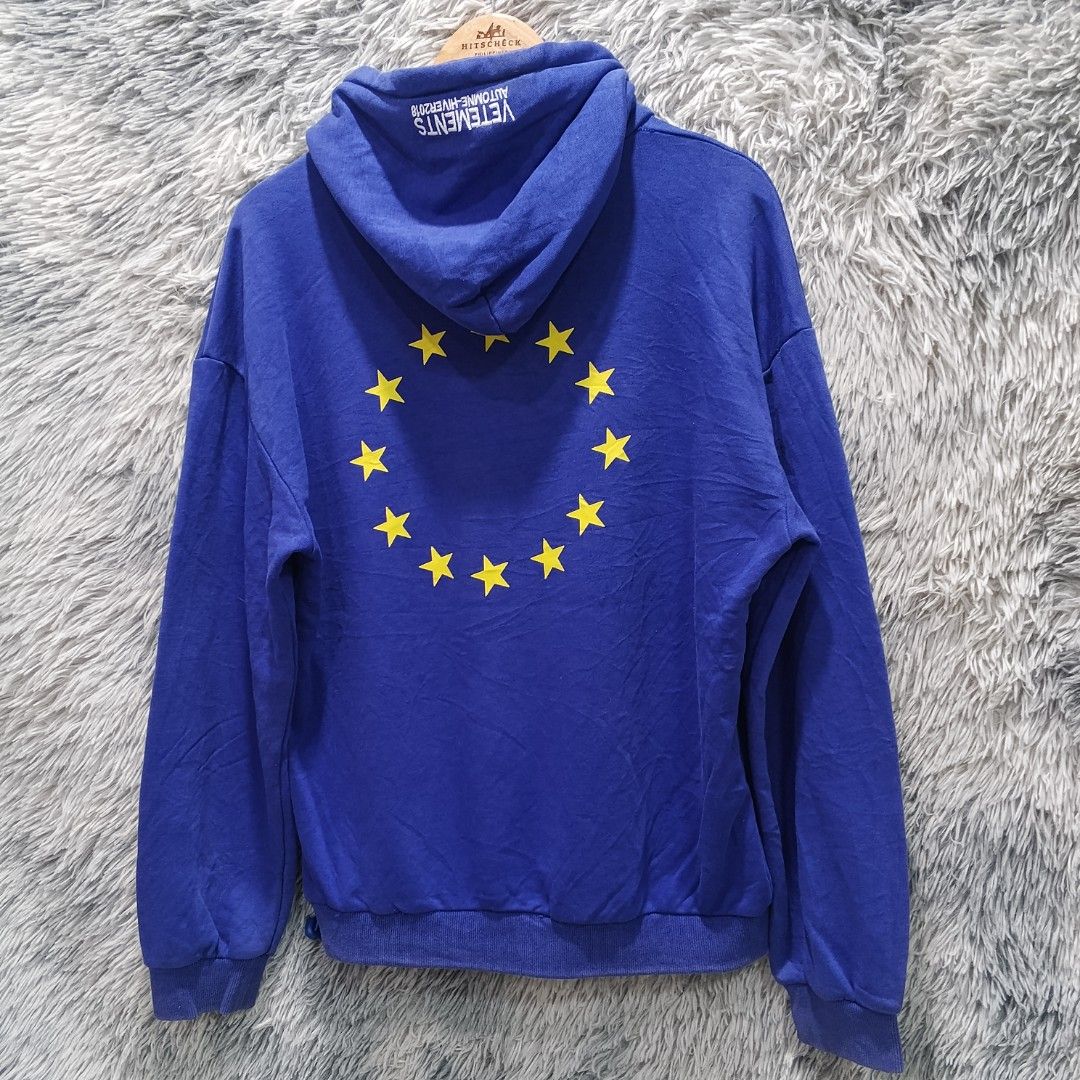 Vetements Blue Hoodie (Category: Hoodies) located in Malasiqui. Submitted by drie_findss (Listing ID 1438921334, Image 3). Description: Vetements Yellow Euro Symbol Blue Pullover Hoodie (Authentic) ‎_______________________ ‎Size: L on tag ‎(Measured by Inches) ‎Width: 23 ‎Length: 25 ‎Shoulder: 24 ‎Sleeve: 22.5 ‎Condition: EXCELLENT ‎Color Rate: 10/10 ‎Issue: None ‎_______________________ ‎ ‎Color may vary due to lightning so check wisely. ‎Thank 
