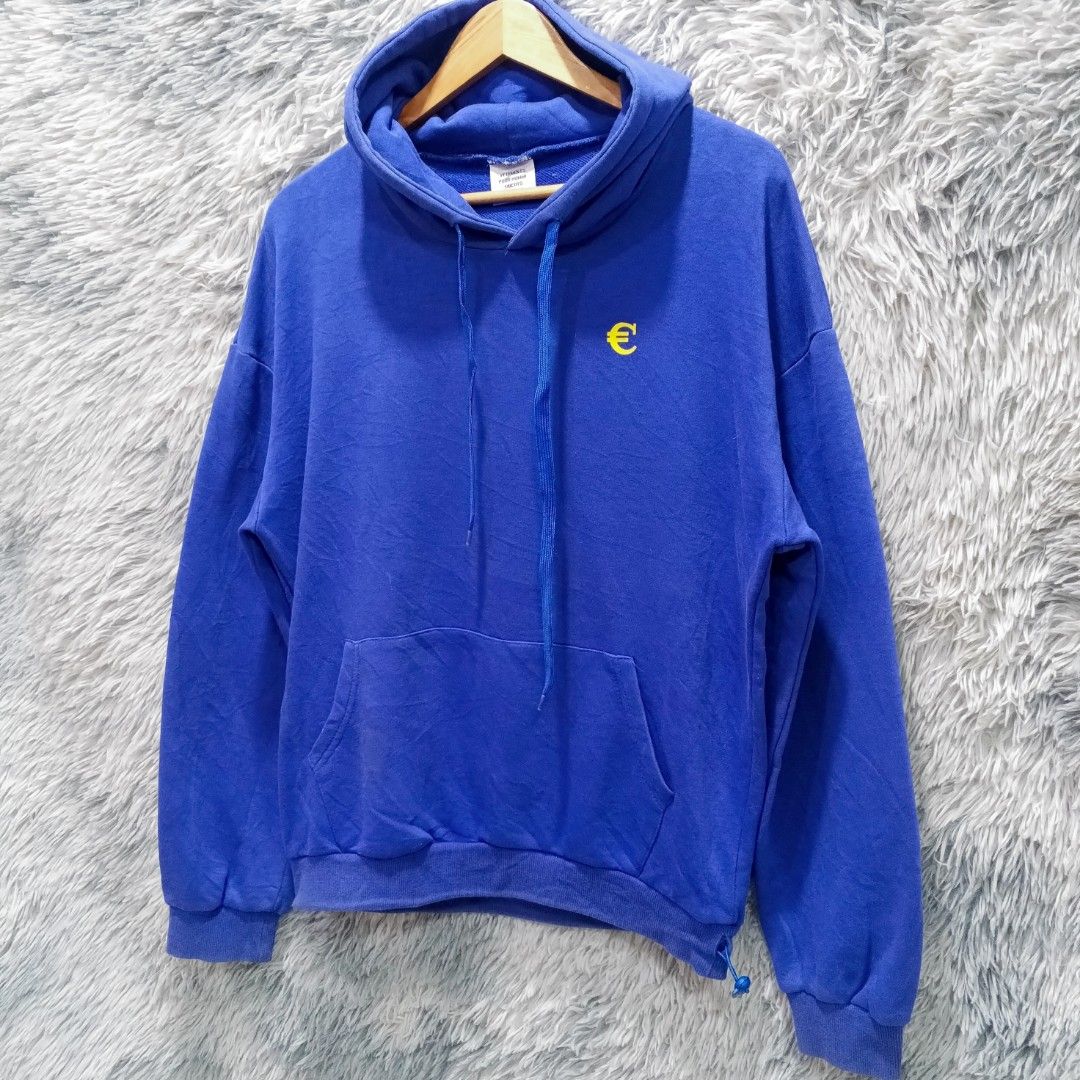 Vetements Blue Hoodie (Category: Hoodies) located in Malasiqui. Submitted by drie_findss (Listing ID 1438921334, Image 2). Description: Vetements Yellow Euro Symbol Blue Pullover Hoodie (Authentic) ‎_______________________ ‎Size: L on tag ‎(Measured by Inches) ‎Width: 23 ‎Length: 25 ‎Shoulder: 24 ‎Sleeve: 22.5 ‎Condition: EXCELLENT ‎Color Rate: 10/10 ‎Issue: None ‎_______________________ ‎ ‎Color may vary due to lightning so check wisely. ‎Thank 