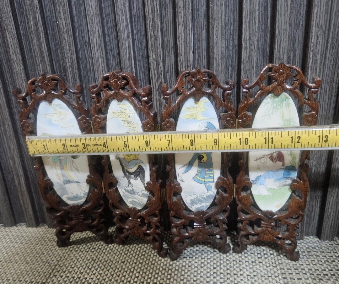 Vintage Miniature Folding Screen (Category: Vintage Collectibles) located in Rizal. Submitted by cherry_garcia (Listing ID 1438940672, Image 3). Description: - Vintage miniature folding screen - Features four panels - Each panel with a traditional Chinese painting - Made of dark wood - Intricate carvings around oval paintings - Includes a stand for display - Connected by hinges - Decorative item.