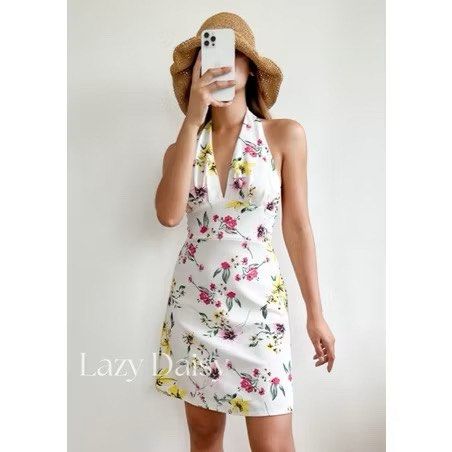 White Floral Halter Dress (Category: Dresses) located in Pasig City. Submitted by amazingfindss (Listing ID 1438928571, Image 3). Description: - White halter dress - Floral print - V-neckline - Open back - Fitted bodice - Flared skirt - Lightweight and comfortable - Ideal for summer or casual events.