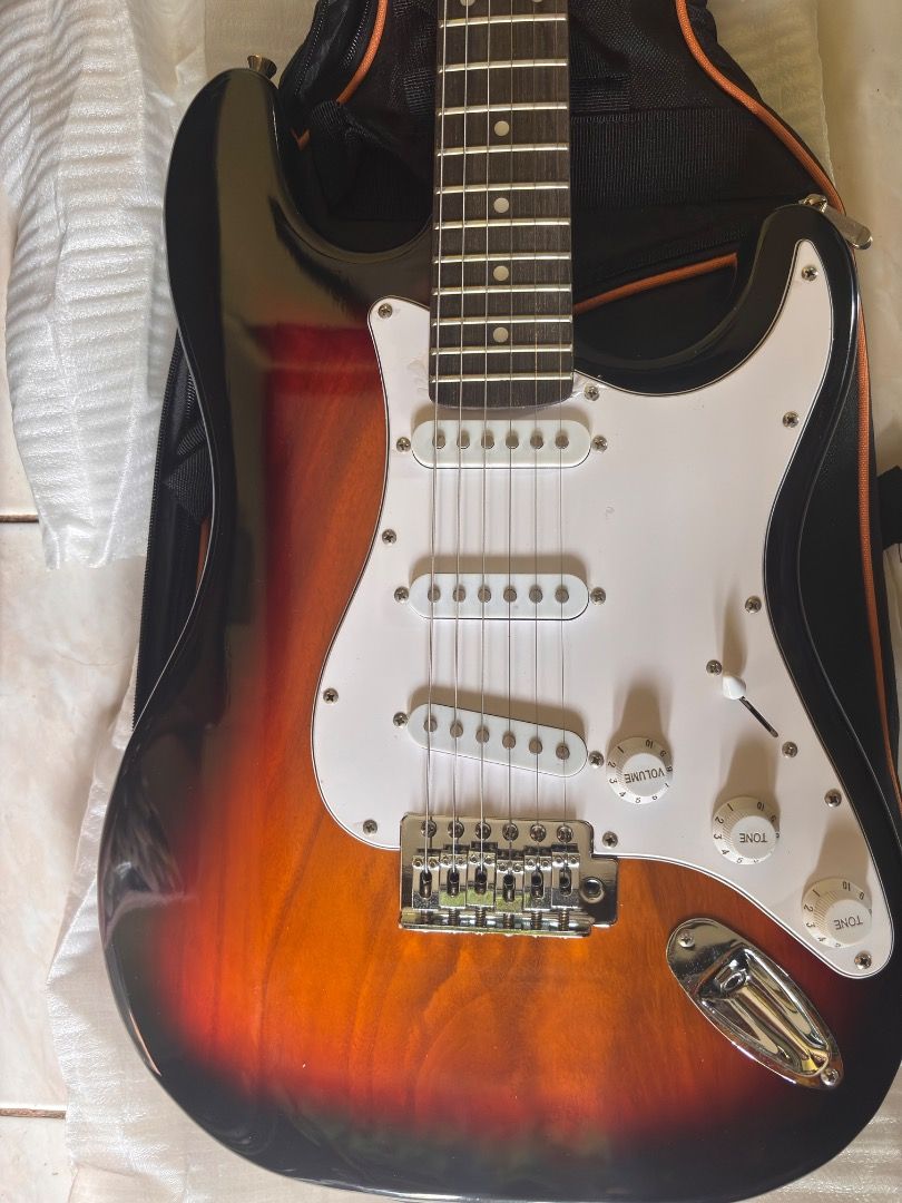 YIFENLI Electric Guitar with Case (Category: Musical Instruments) located in Caloocan City. Submitted by blackstar1019 (Listing ID 1438881003, Image 3). Description: 39 inch Electric Guitar ST Electric Guitar Telecaster w/ accesories - Sunburst finish - White pickguard - Three pickups - Tremolo bridge - Includes a black guitar case with orange trim - Comes with a cable - Brand new in original packaging.