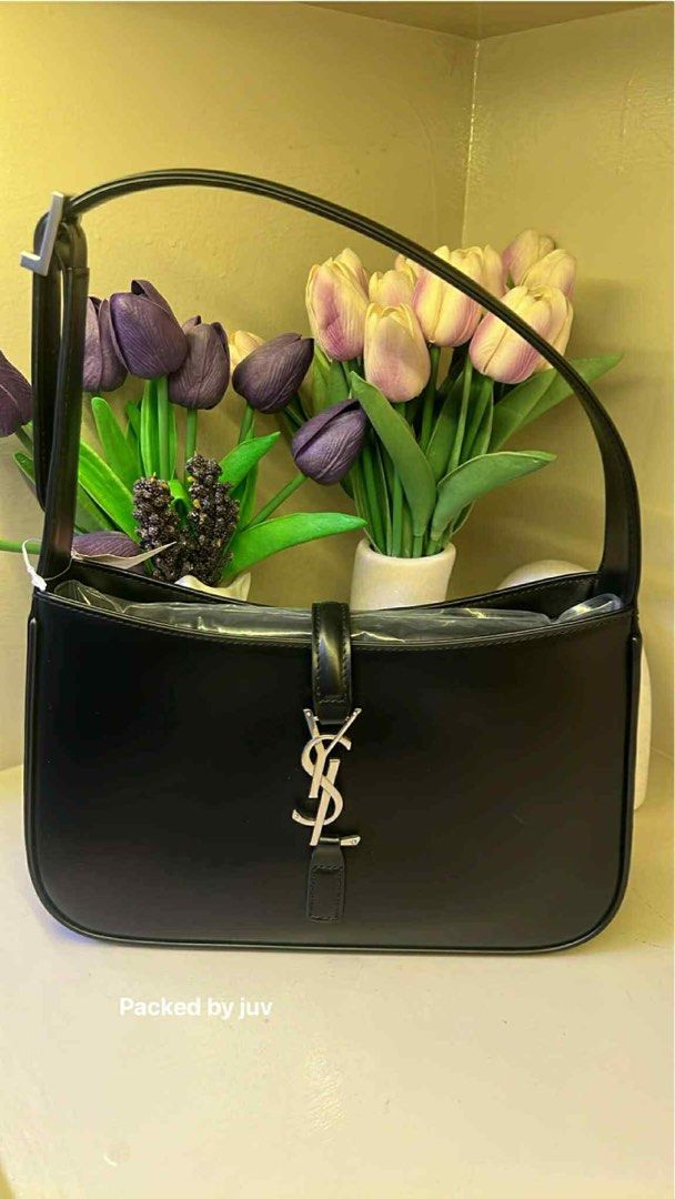 YSL Hobo Bag Black (Category: Luxury Bags & Wallets) located in Hermosa. Submitted by bookwormhermosa (Listing ID 1438894298, Image 3). Description: - Authentic YSL hobo bag - Black leather - Silver-tone hardware - Shoulder strap - Flap closure with YSL logo - Lined interior - Sleek and classic design - Suitable for various occasions.