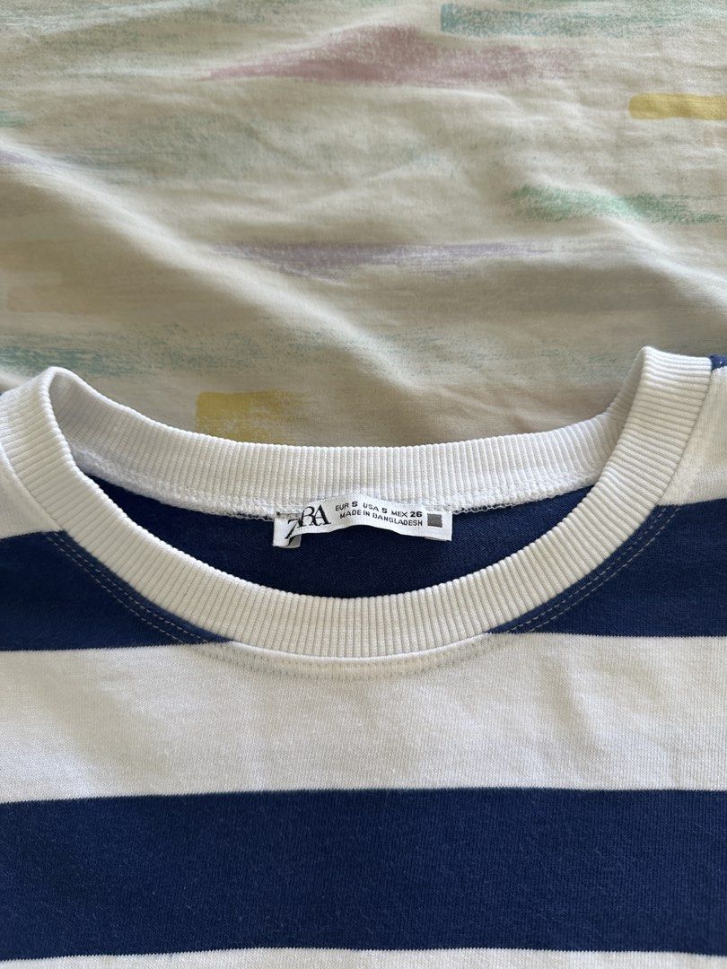 Zara Striped Cropped Top (Category: Blouses) located in Paranaque City. Submitted by declutterwyae (Listing ID 1438887788, Image 2). Description: - Zara cropped top - Size: S - Color: Navy blue and white stripes - Features: Round neckline, short sleeves - Style: Cropped design, perfect for casual wear - Fabric: Comfortable.