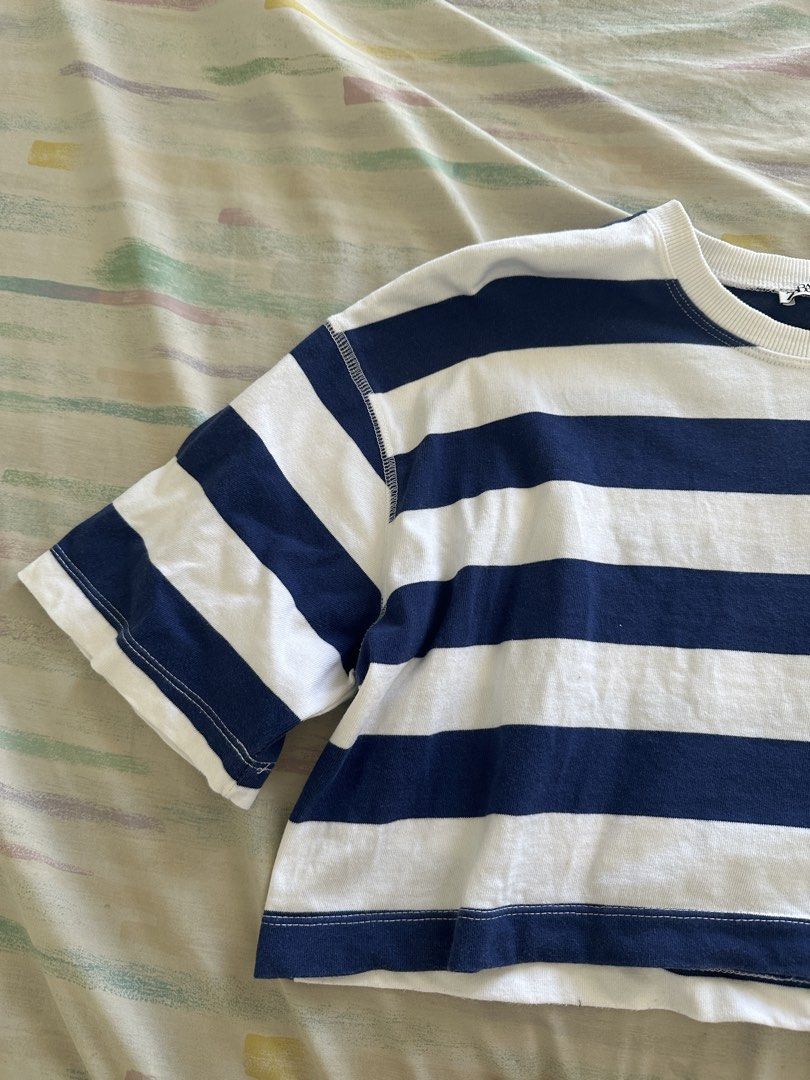 Zara Striped Cropped Top (Category: Blouses) located in Paranaque City. Submitted by declutterwyae (Listing ID 1438887788, Image 3). Description: - Zara cropped top - Size: S - Color: Navy blue and white stripes - Features: Round neckline, short sleeves - Style: Cropped design, perfect for casual wear - Fabric: Comfortable.